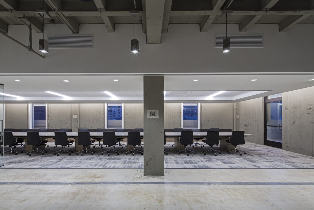 big conference room with chairs inside and grey walls